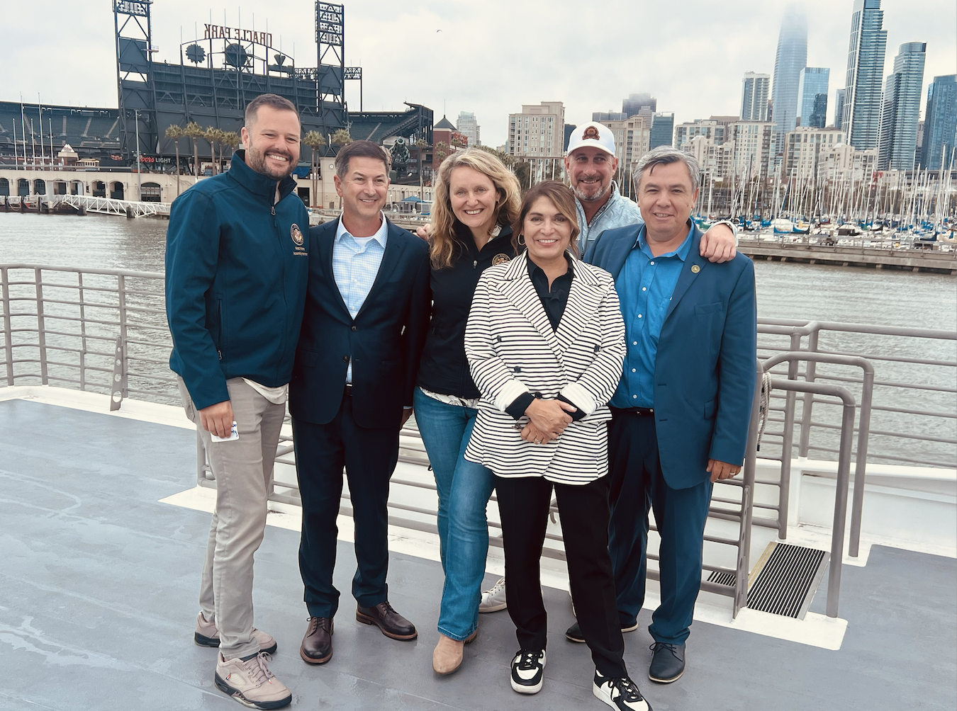 Members of the Select Committee on Permitting Reform pose on ferry boat in front of San Francisco skyline.